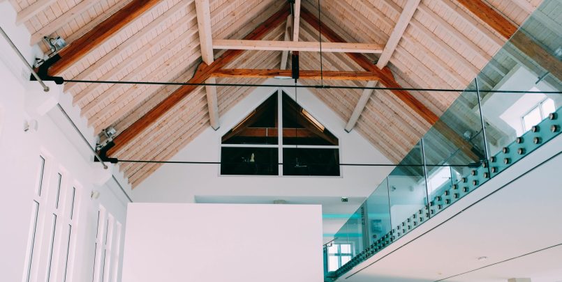 A low angle shot of a wooden ceiling in a cool house with a modern minimalistic interior